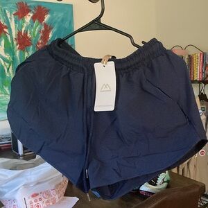 Running shorts with liner and 3 zipper pockets. New and still in bag.